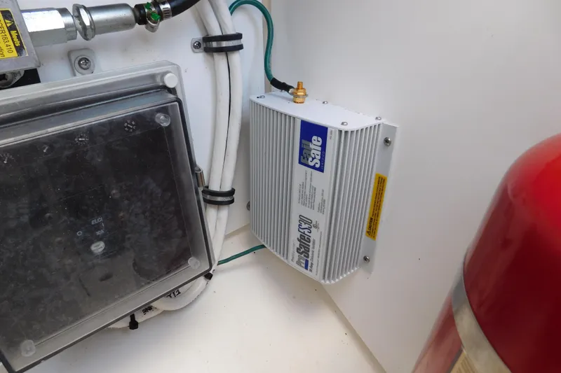 Slide: The Image of Electrical components inside a 2024 Pursuit DC 326 Dual Console boat. - 90