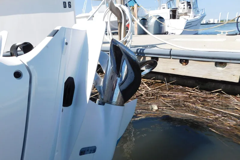 Slide: The Image of 2024 Pursuit DC 326 Dual Console boat docked with visible propeller and marina background. - 96