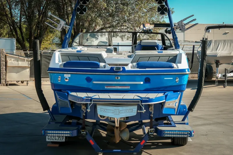 Slide: The Image of 2021 Malibu Wakesetter 23 LSV boat, blue, parked on a trailer in a marina. - 10
