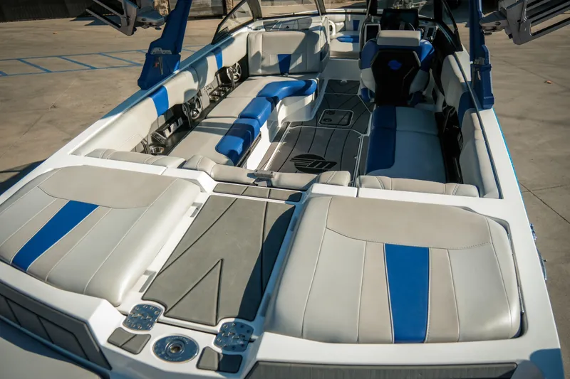 Slide: The Image of 2021 Malibu Wakesetter 23 LSV interior with blue and gray seating, showcasing luxury design. - 13