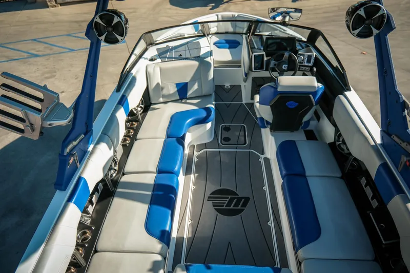 Slide: The Image of 2021 Malibu Wakesetter 23 LSV interior with blue and white seating, modern dashboard, and speakers. - 15