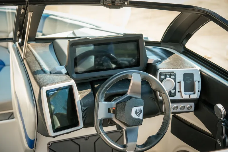 Slide: The Image of 2021 Malibu Wakesetter 23 LSV dashboard with modern steering and digital displays. - 17