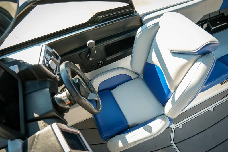 Slide: The Image of 2021 Malibu Wakesetter 23 LSV cockpit with blue and white seating, steering wheel, and controls. - 19