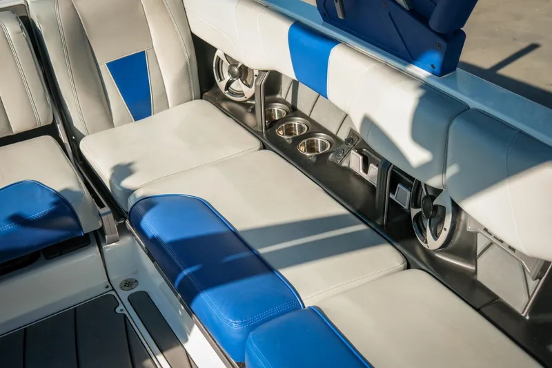 Slide: The Image of 2021 Malibu Wakesetter 23 LSV interior with blue and gray seating, cup holders, and speakers. - 22