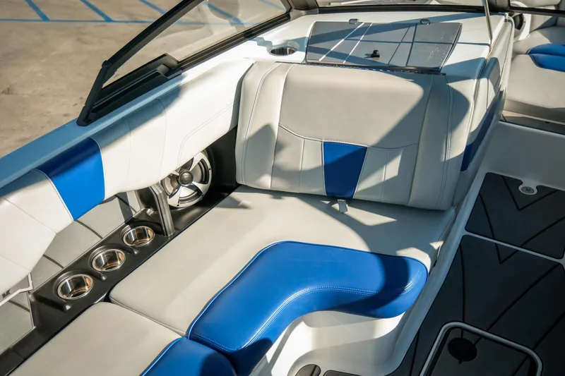 Slide: The Image of 2021 Malibu Wakesetter 23 LSV interior with blue and white seating and cup holders. - 23
