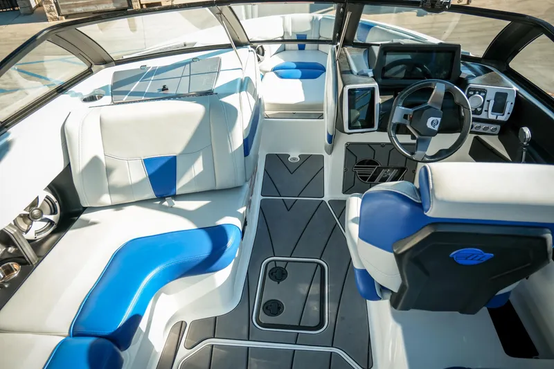 Slide: The Image of Interior of 2021 Malibu Wakesetter 23 LSV boat with blue and white seating. - 24