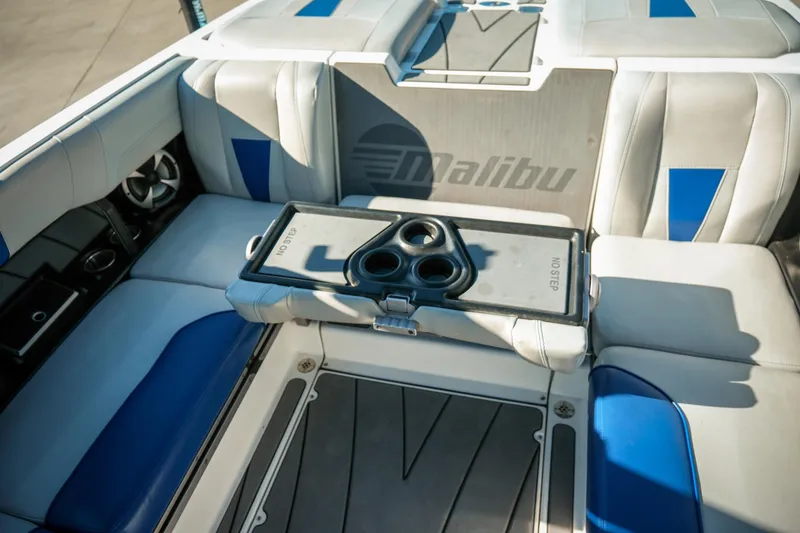 Slide: The Image of 2021 Malibu Wakesetter 23 LSV interior with cup holders and blue-accented seating. - 26