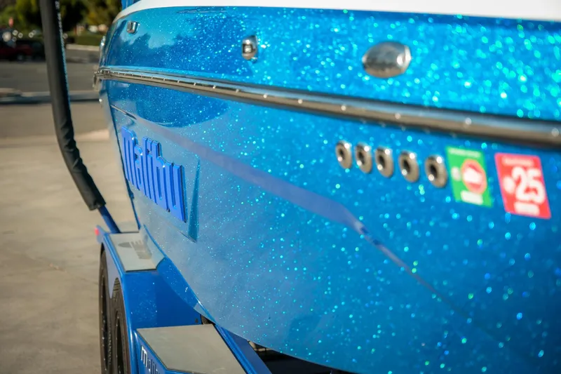 Slide: The Image of 2021 Malibu Wakesetter 23 LSV with sparkling blue finish, side view. - 33