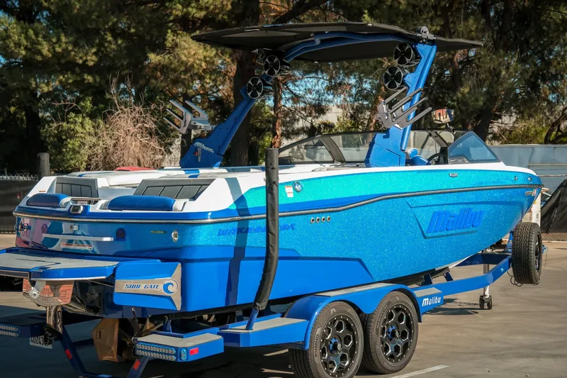 Slide: The Image of 2021 Malibu Wakesetter 23 LSV boat in vibrant blue on a trailer. - 9