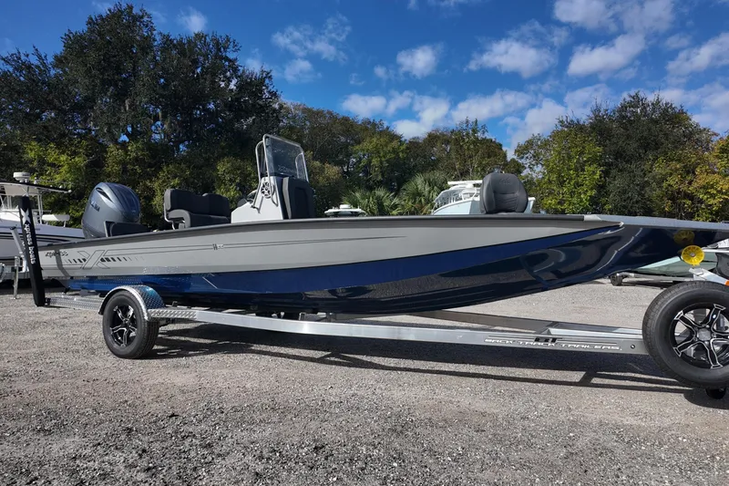 The Image of 2026 Xpress H22B Bay boat on trailer, parked outdoors under blue sky. - 0