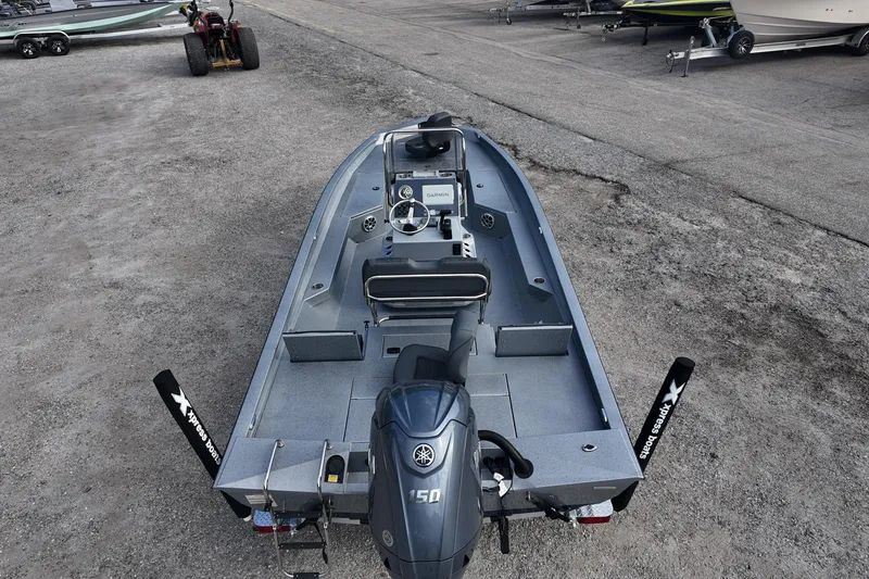 Slide: The Image of 2026 Xpress H22B Bay boat with Yamaha 150 engine, parked on a concrete surface. - 14