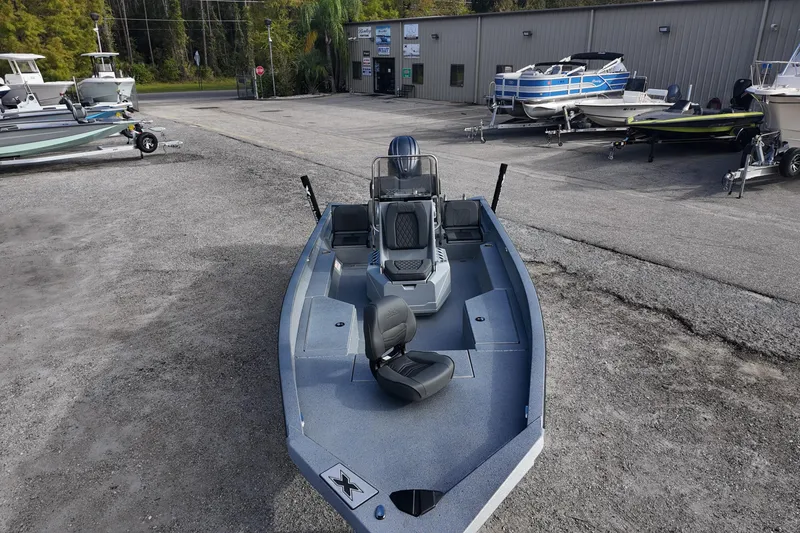 Slide: The Image of 2026 Xpress H22B Bay boat displayed at a dealership with other boats. - 15