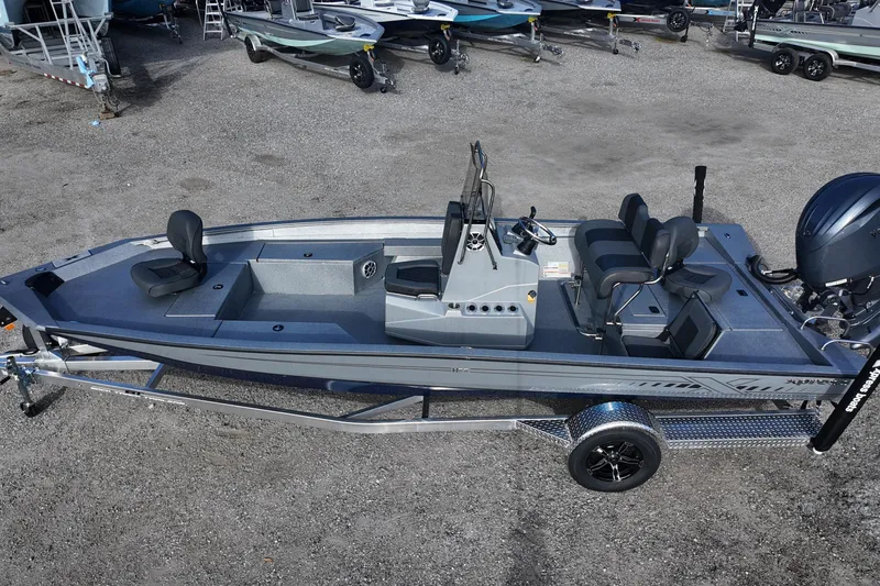 Slide: The Image of 2026 Xpress H22B Bay boat on trailer, featuring sleek design and modern seating. - 2