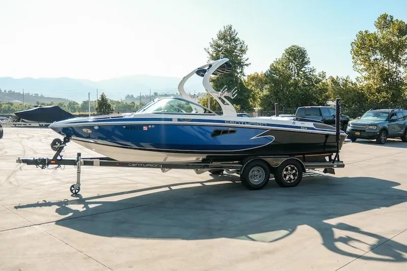 The Image of 2014 Centurion Enzo SV233 boat on trailer in sunny outdoor setting. - 1
