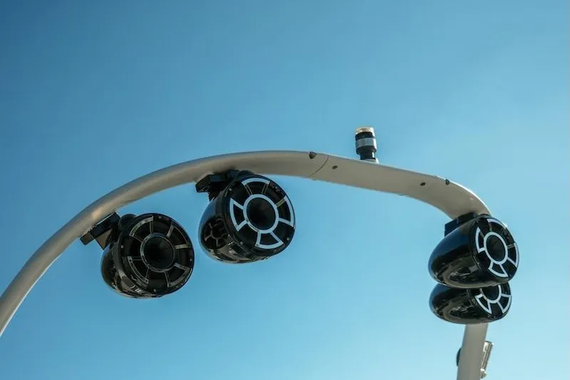 Slide: The Image of Speakers on a 2014 Centurion Enzo SV233 boat against a clear blue sky. - 11