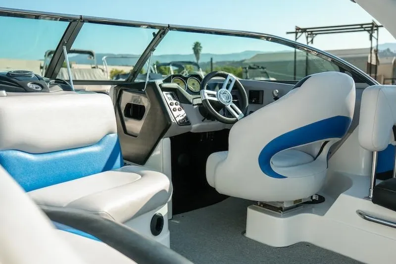 Slide: The Image of Interior of a 2014 Centurion Enzo SV233 boat with blue and white seating. - 13