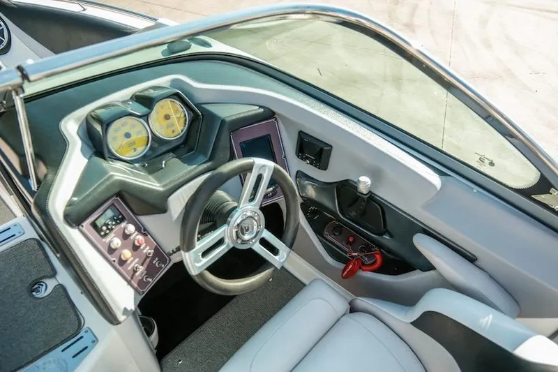 Slide: The Image of 2014 Centurion Enzo SV233 boat dashboard with steering wheel and control panel. - 16