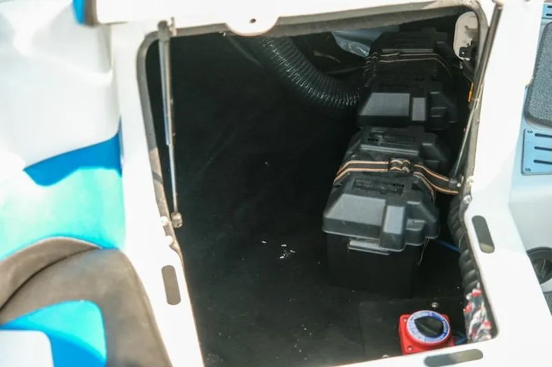 Slide: The Image of 2014 Centurion Enzo SV233 boat interior storage compartment with battery setup. - 26
