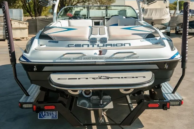Slide: The Image of 2014 Centurion Enzo SV233 boat, rear view, showcasing sleek design and branding. - 4