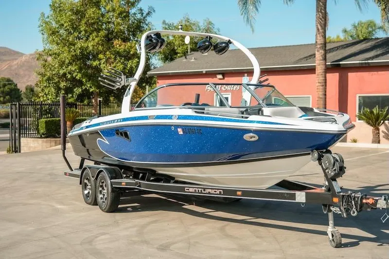 Slide: The Image of 2014 Centurion Enzo SV233 boat on trailer, parked outdoors near a building. - 7