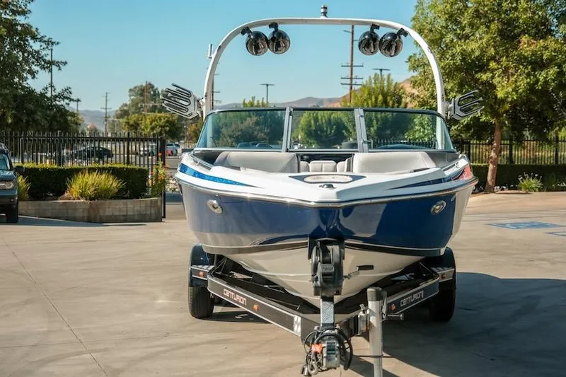 Slide: The Image of 2014 Centurion Enzo SV233 boat on trailer, parked outdoors, sunny day. - 8