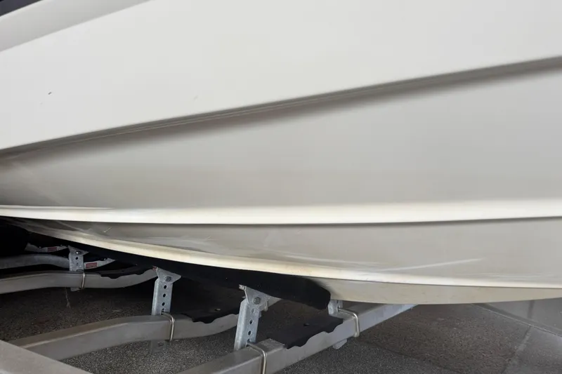 Slide: The Image of 2017 Formula 240 Bowrider boat with open storage compartment, red and white design. - 13