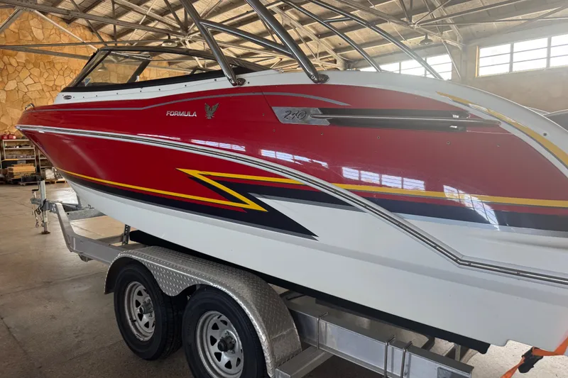 Slide: The Image of 2017 Formula 240 Bowrider boat interior with white seating and open storage compartment. - 18