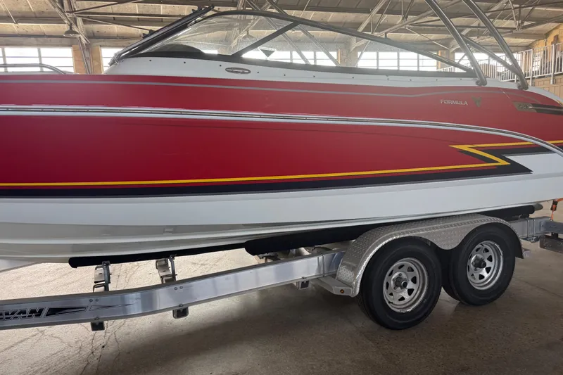 Slide: The Image of Interior view of a 2017 Formula 240 Bowrider boat with seating and cup holders. - 20