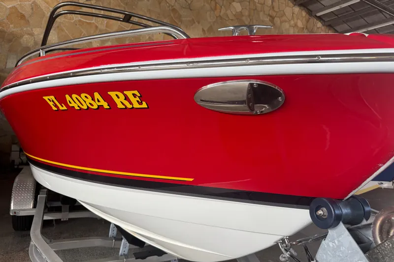 Slide: The Image of 2017 Formula 240 Bowrider boat on trailer, vibrant red hull, parked outdoors. - 3