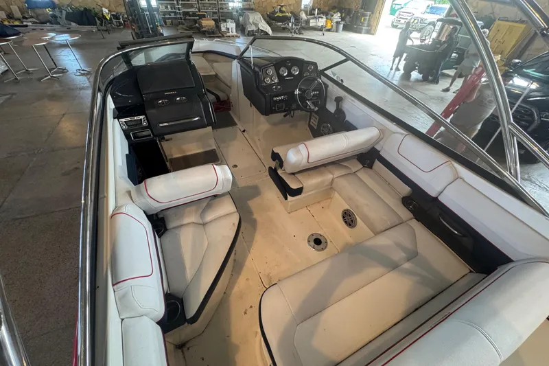 Slide: The Image of 2017 Formula 240 Bowrider boat interior with white seating and red accents. - 44