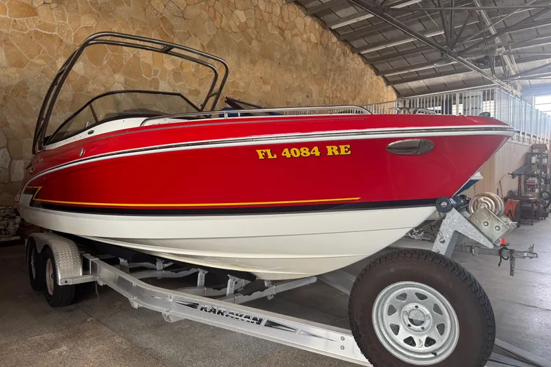 Slide: The Image of Red 2017 Formula 240 Bowrider boat on trailer in a garage setting. - 5