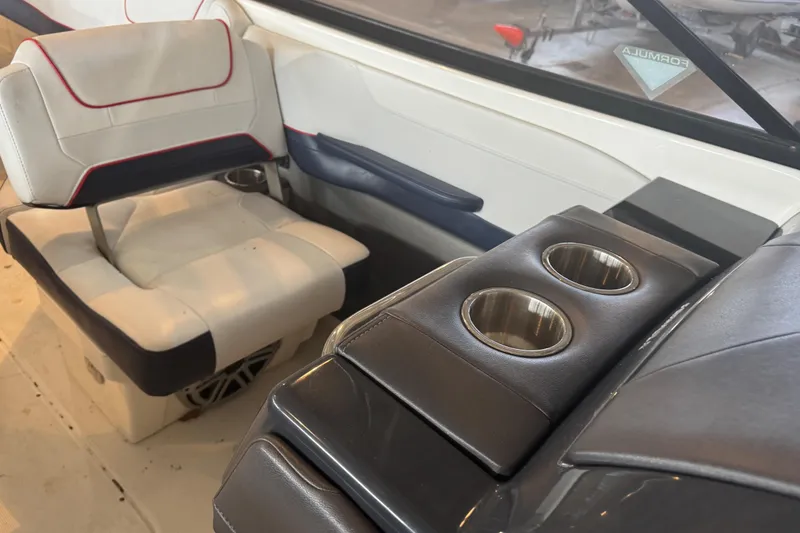 Slide: The Image of 2017 Formula 240 Bowrider boat in a warehouse, red and white exterior, on a trailer. - 59