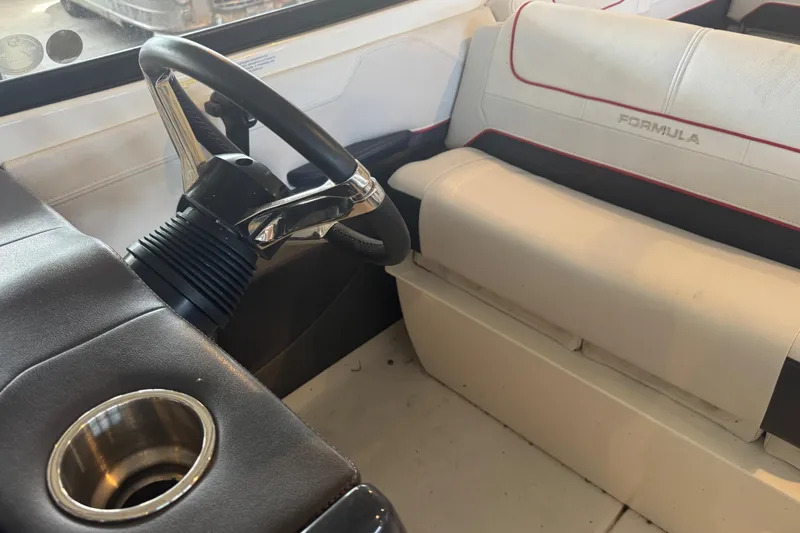 Slide: The Image of 2017 Formula 240 Bowrider boat in red on a trailer inside a warehouse. - 60