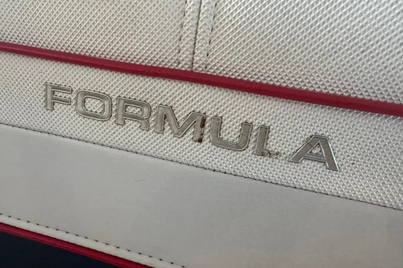 Slide: The Image of 2017 Formula 240 Bowrider boat in storage, vibrant red hull on trailer. - 61