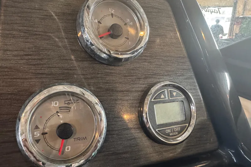 Slide: The Image of 2017 Formula 240 Bowrider boat in a garage, red and white design, on a trailer. - 63