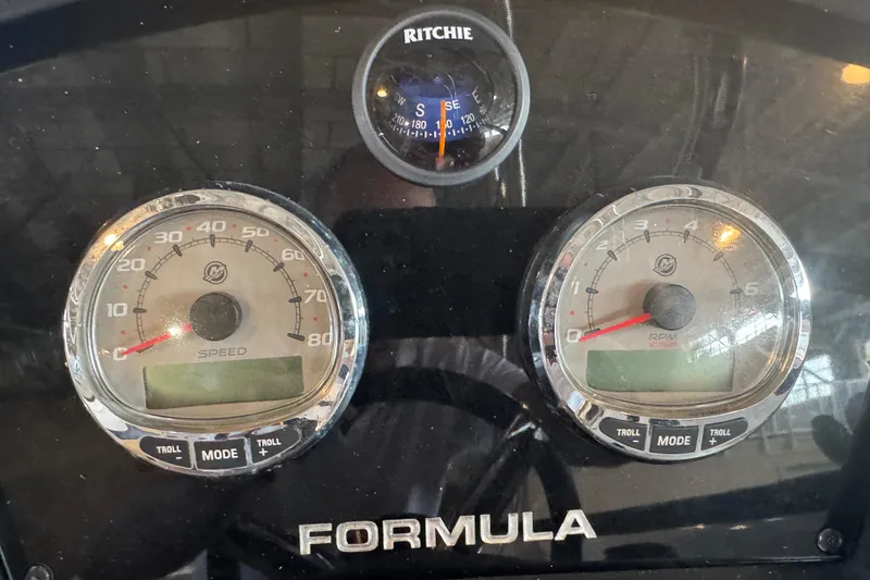 Slide: The Image of 2017 Formula 240 Bowrider boat in a warehouse, red and white design, on a trailer. - 65