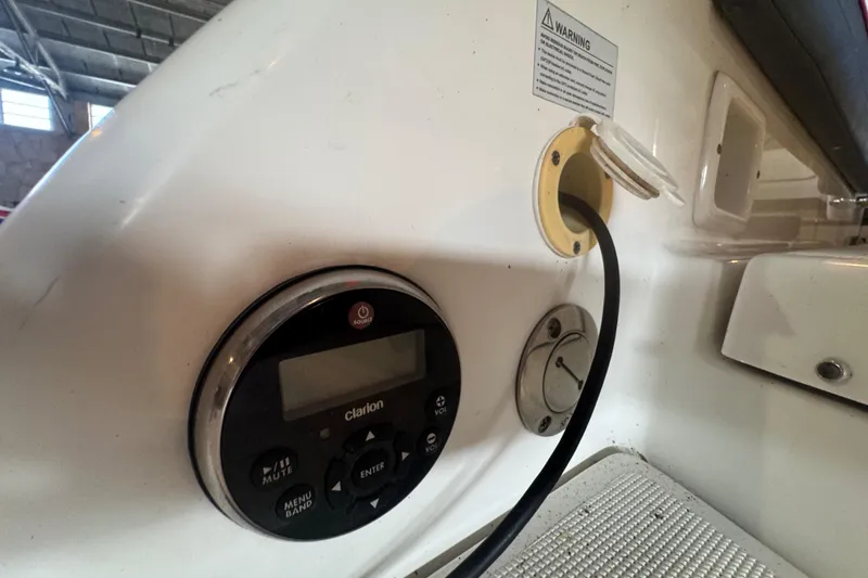 Slide: The Image of 2017 Formula 240 Bowrider boat in a warehouse, red and white design on trailer. - 74