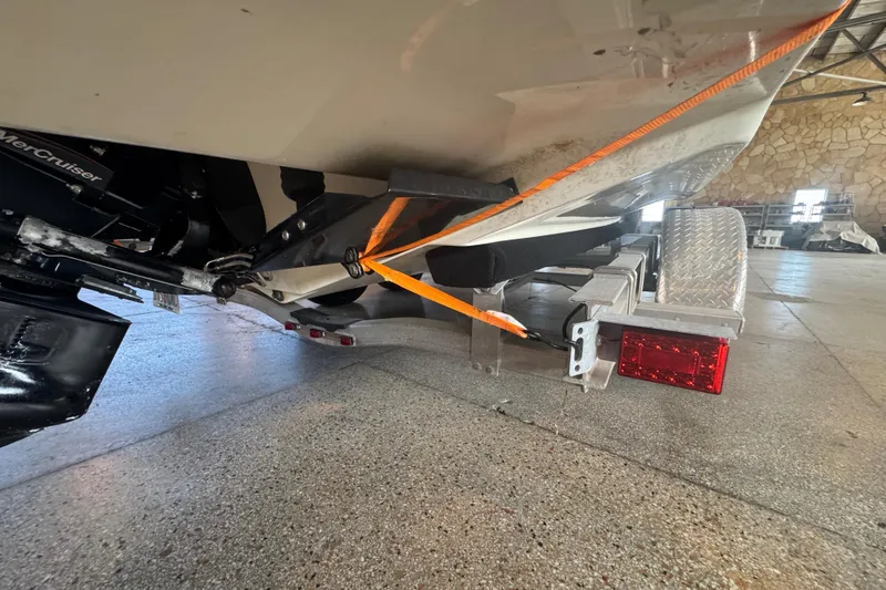 Slide: The Image of 2017 Formula 240 Bowrider in storage, vibrant red and white design, on a trailer. - 77