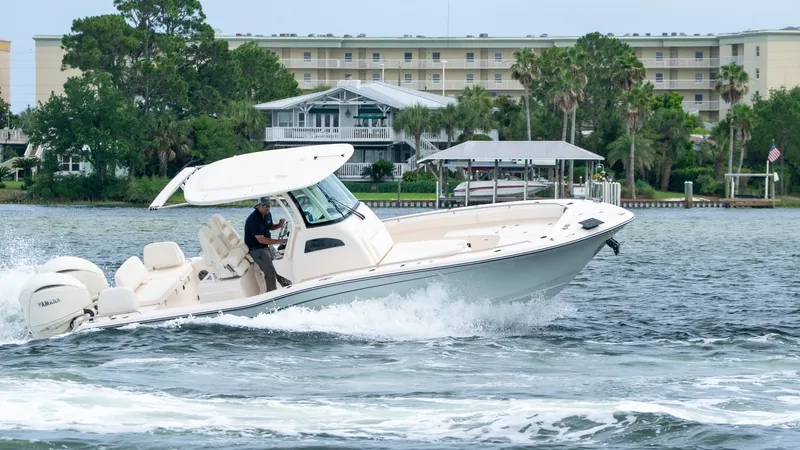 Slide: The Image of Grady-White 281 Coastal Explorer 2026 cruising on water near buildings. - 10