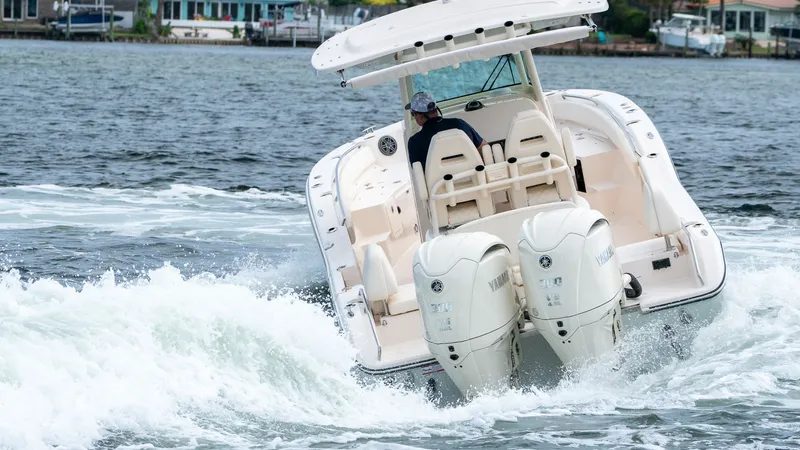 Slide: The Image of 2026 Grady-White 281 Coastal Explorer on water with dual outboard engines. - 7