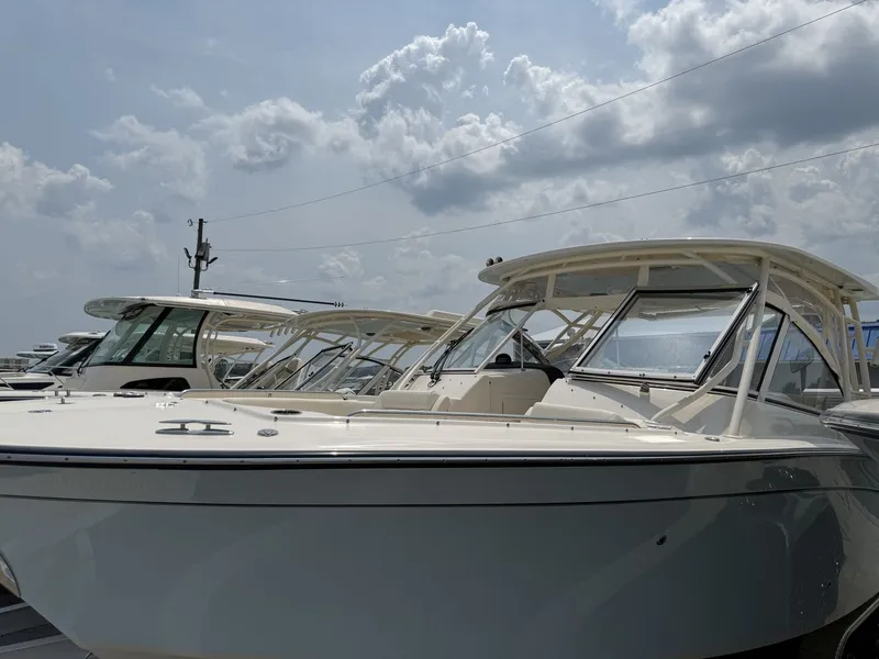 Slide: The Image of A 2026 Grady-White Freedom 307 boat is outdoors under a cloudy sky. - 1