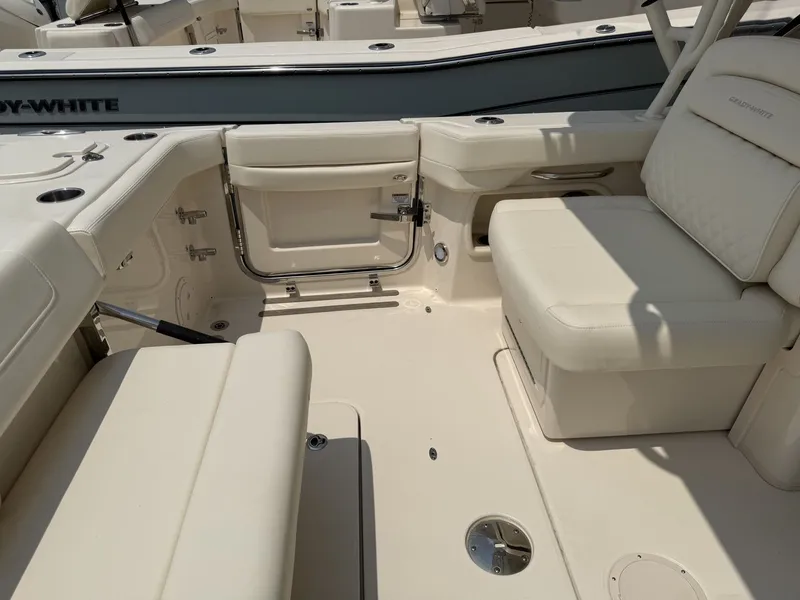 Slide: The Image of The image shows the cockpit of a Grady-White Freedom 307 boat with beige upholstery. - 13
