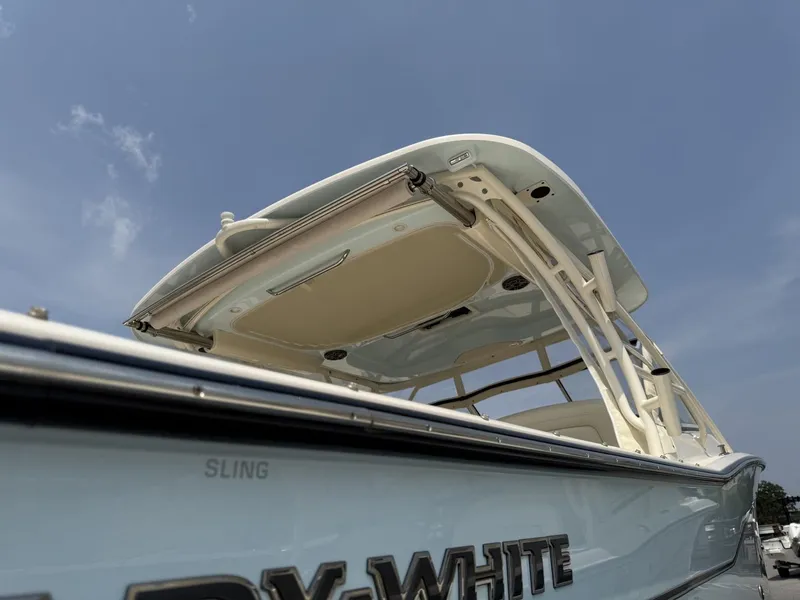 Slide: The Image of The image shows a Grady-White Freedom 307 boat with a sturdy roof and sleek lines. - 9