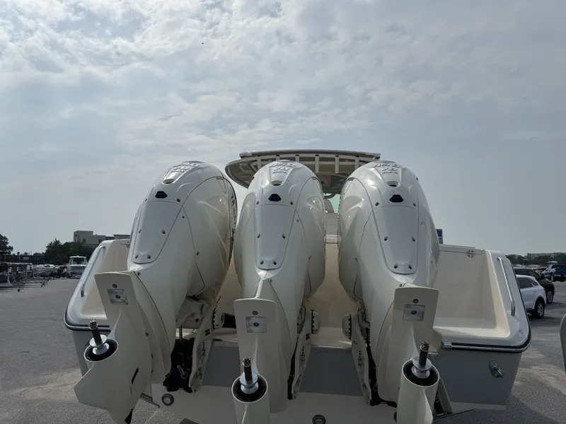 Slide: The Image of Three powerful outboard engines are mounted on the stern of a Grady-White Canyon 386 boat. - 8