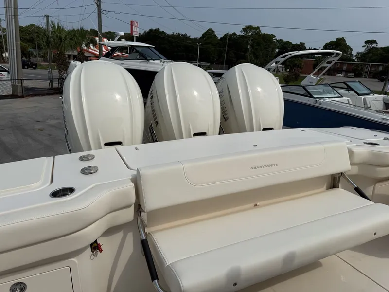 Slide: The Image of The image shows the stern of a Grady-White Canyon 386 with three outboard engines. - 23