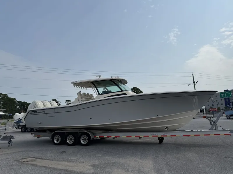 Slide: The Image of A 2027 Grady-White Canyon 386 sits on a trailer in a parking lot. - 0