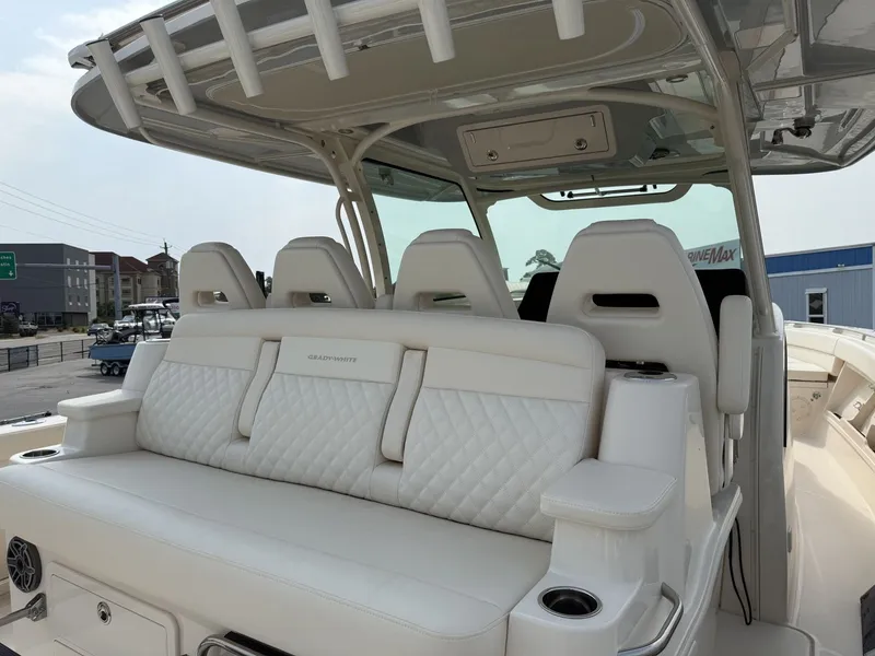 Slide: The Image of The image shows the cockpit of a Grady-White Canyon 386 boat with white, cushioned seating. - 25