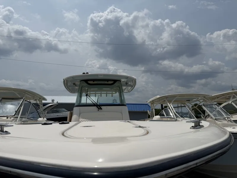 Slide: The Image of The image shows the bow of a Grady-White Canyon 336 boat under a cloudy sky. - 2