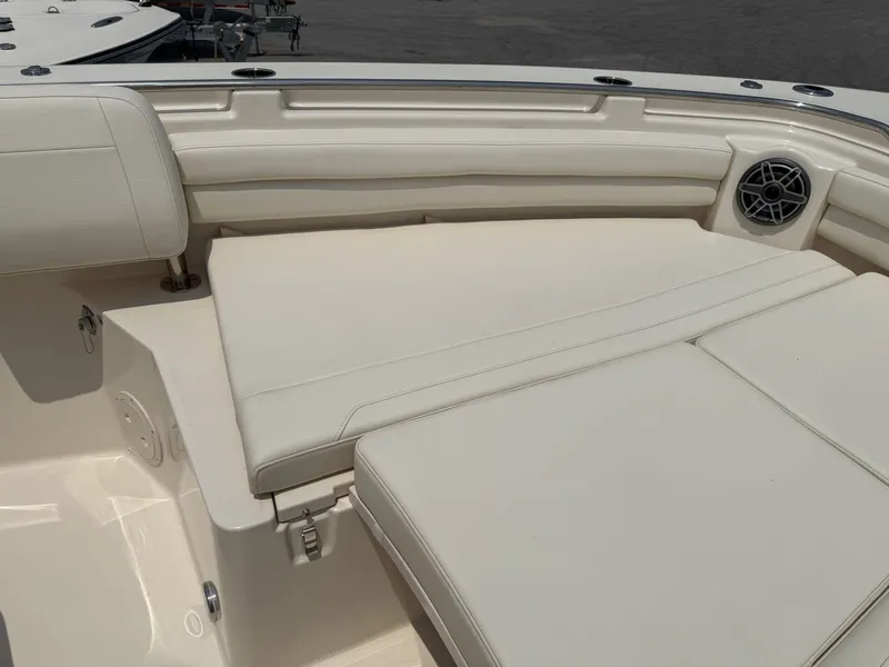 Slide: The Image of The image shows the cockpit of a Grady-White Canyon 336 with beige upholstery and a speaker. - 25