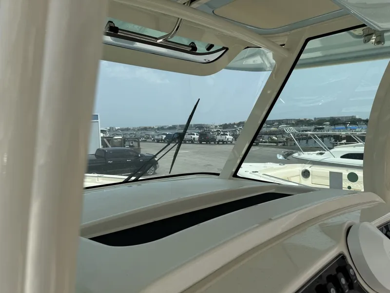 Slide: The Image of View from the cockpit of a Grady-White Canyon 336 overlooking a marina with several boats. - 20
